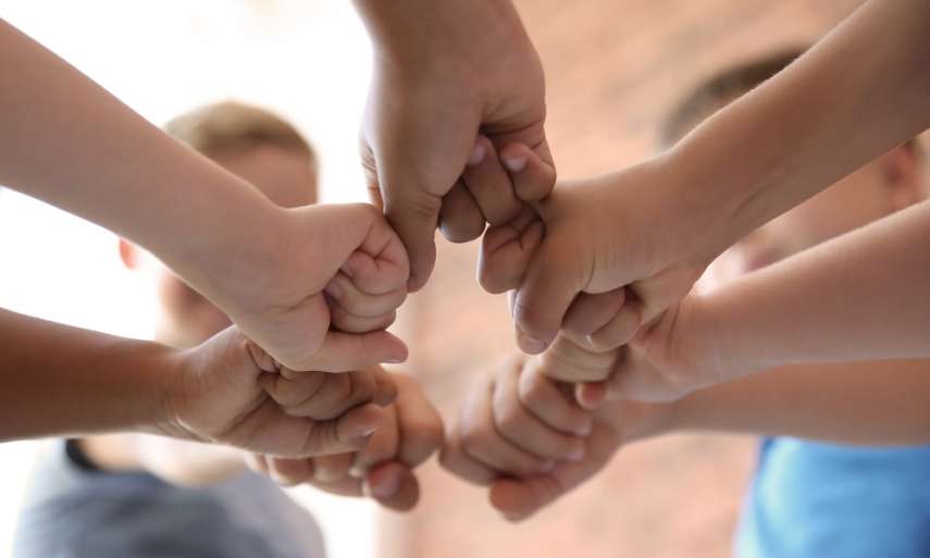 Hands joined signifying team unity.