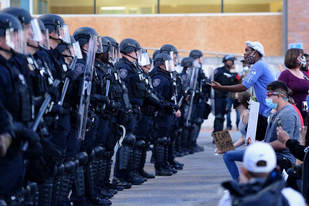 Protester facing off with Law Enforcement.